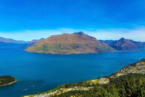 The concept of active, ecological and photo tourism. Bird's eye view. The city Queenstown, shores