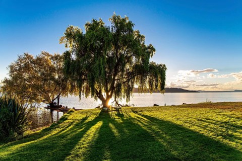 Magnificent sunset. Warm evening on the lake. New Zealand. The largest Lake Taupo. The magnificent