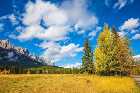 The Three Sisters mountains in Canadian Rockies. Shining autumn day in Canmore. Mountain peaks and