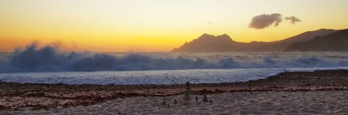 Surf wave at sunset on the beach in Porto, Corsica