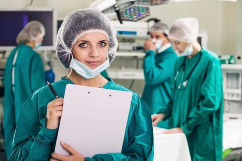 Portrait of surgeons in surgery with doctors working on background