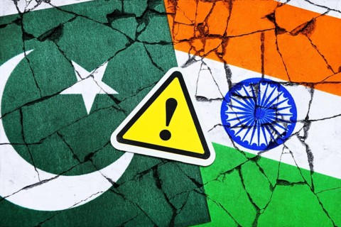 Danger sign with exclamation mark on the flags of Pakistan and India, symbolic photo Kashmir
