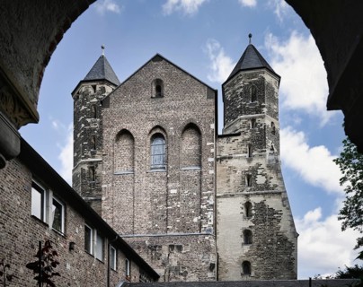 View from the cloister to the west façade of the Romanesque Basilica of St Mary in the Capitol