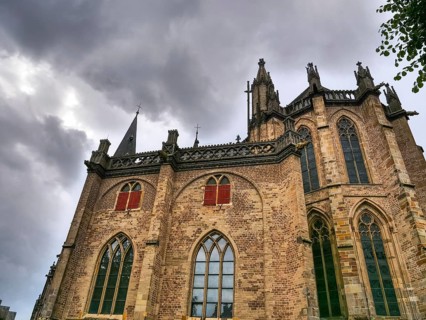 Gothic brick church with high windows and a dramatic, cloudy sky, Xanten, North Rhine-Westphalia,