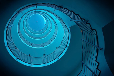 Futuristic spiral staircase in blue light with metallic railings, Free and Hanseatic City of