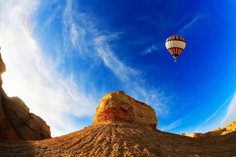 Huge balloon above ancient mountains of the Dead Sea. A sunset