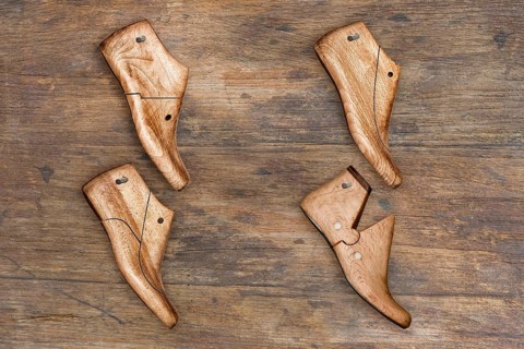 Shoe lasts hanging on a wooden wall