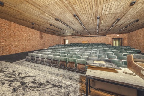 Dilapidated lecture theatre, its floor covered with rubble and dust, Institute of Molecular