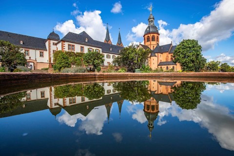 A historic monastery in the morning. Monastery walls, church and buildings are reflected in the