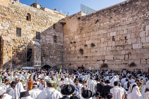 Jerusalem. Jews praying wrapped in festive white Talit. Exciting ceremony at the Western Wall of