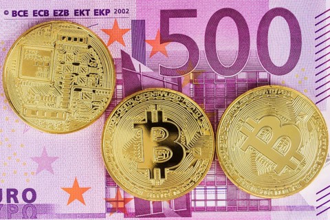 Bitcoin coin on euro banknotes as background
