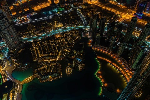 Dubai downtown night scene with city lights. Top view from above