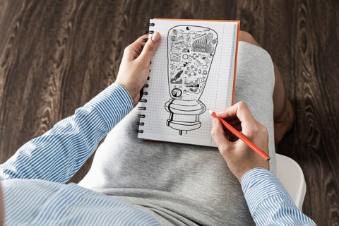 Close-up, woman draws business notes in her notebook. Business Innovation Concept