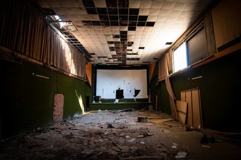 Abandoned and damaged interior of a stage theatre with bright light entering the building, Nicosia