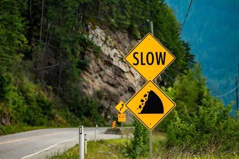 Slow, Watch for fallen rock and be prepared to avoid a collision, Warning yellow roads signs in
