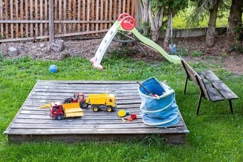 Untidy playground with sandpit in the garden