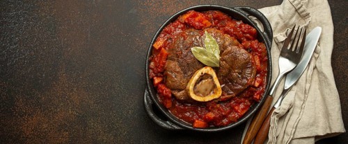 Traditional Italian dish Ossobuco all Milanese made with cut veal shank meat with vegetable tomato