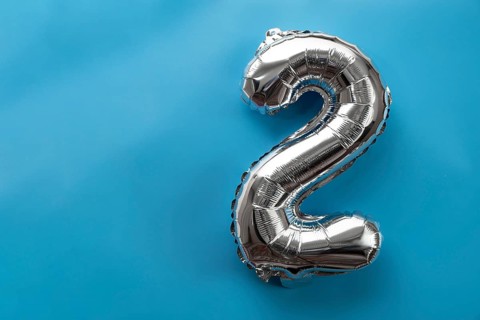 2 two metallic balloon isolated on blue background. Greeting card silver foil balloon number Happy