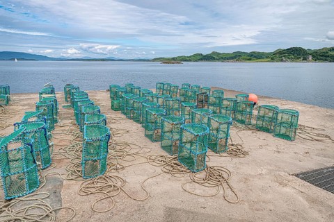 Lobster pots drying on the harbour in Crinan, Argyll and Bute, Scotland, United Kingdom, Europe