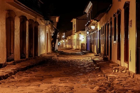 Atmospheric night view of illuminated street and buildings in historical center of Paraty, Brazil,