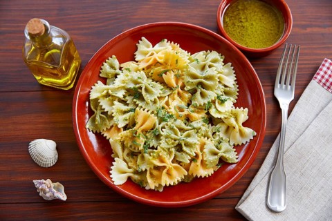 Farfalle pasta with Pesto on wooden table