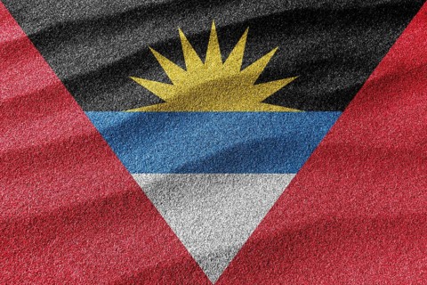 Antigua and Barbuda sand flag, national flag sand background
