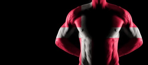 Denmark flag on muscled male torso with abs, black background