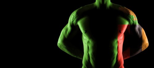 Zambia flag on muscled male torso with abs, black background