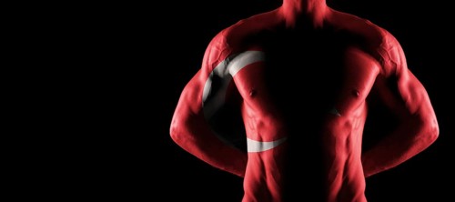 Turkey flag on muscled male torso with abs, black background