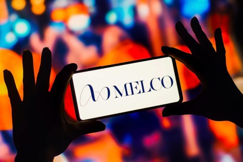 In this photo illustration, the Melco Resorts and Entertainment Limited logo is displayed on a