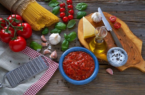 Italian Spaghetti pasta food with cheese tomato garlic basil on wood