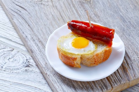 Pinchos pintxos chistorra with quail egg tapas from Spain sausage food