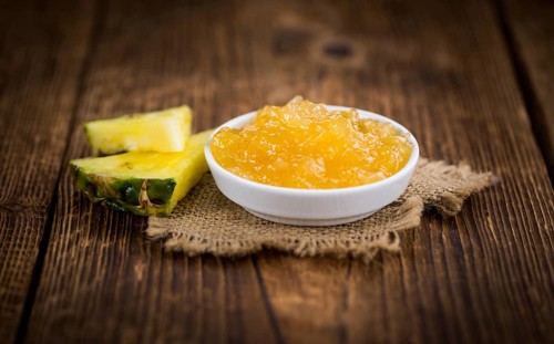 Fresh made Pineapple Jam on a vintage background as detailed close-up shot