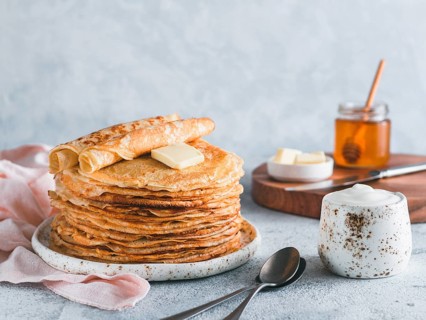 Stack of traditional russian pancakes blini on gray background with copy space. Homemade russian