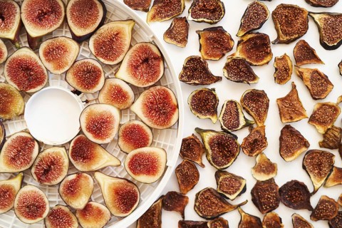 Sliced fresh and dried figs lie on the table. Top view.