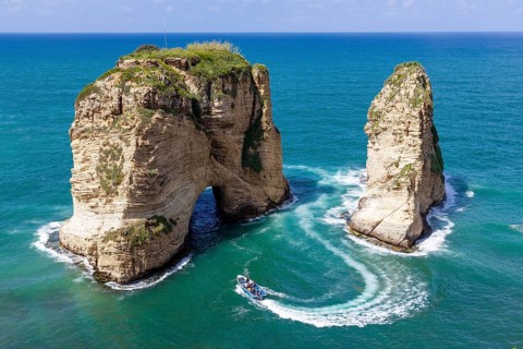 Rouche rocks in Beirut, Lebanon in the sea during daytime. Pigeon Rocks in Mediterranean sea