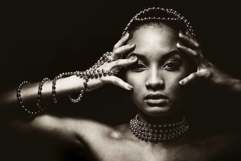 Upscale Indian woman wearing chain jewellery and beautiful makeup. Black and white photo.
