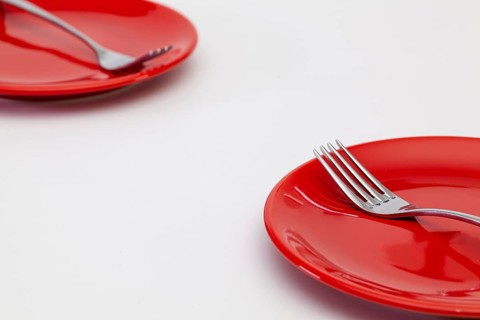 Red plates on the white wooden table.Top view. Flat Lay Image