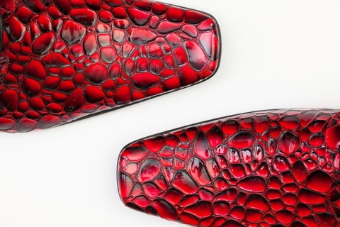 Detail of men's red shoes on white background