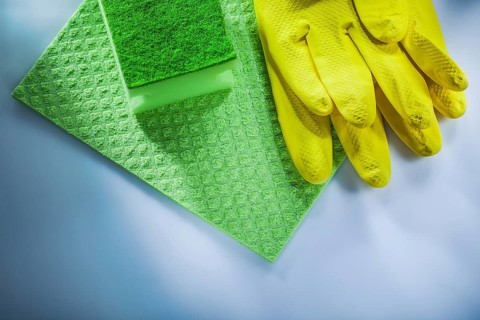 Household washcloth sponge safety gloves on white surface