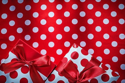 Decorated presents on polka-dot red table cloth holidays concept