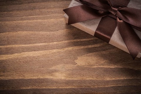 Packed present on vintage wooden board copy space holidays concept