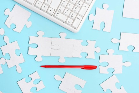 Building An Unfinished White Jigsaw Pattern Puzzle With Missing Last Piece