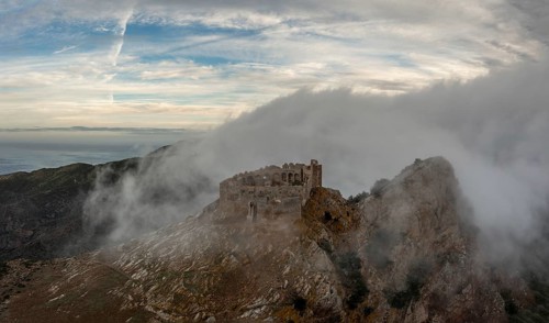 Magazzini, Italy, 14 November, 2023: drone view of the Castello del Volterraio shrouded in morning