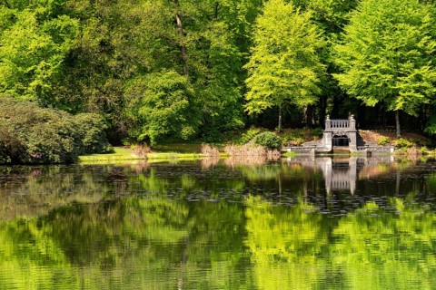 Lake with artificial waterfall in the royal palace park Kroondomein in the Dutch city Apeldoorn