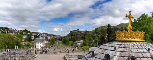 Lourdes, France, 17 April, 2024: view of the town of Lourdes with the hilltop castle and the cupola