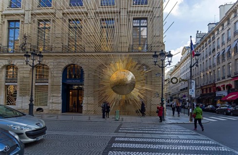 PARIS, FRANCE, DECEMBER 17, 2017: Sculpture on the facade of the building, the sun emits rays.