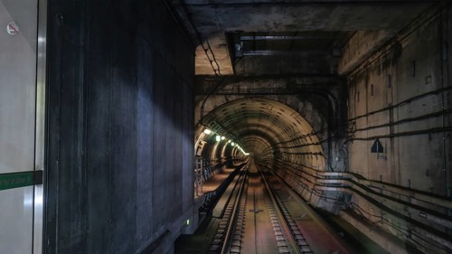 View on rails in metropolitan tube in lamps light