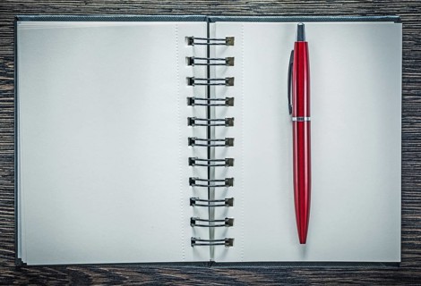 Spiral notepad ballpoint pen on vintage wooden board