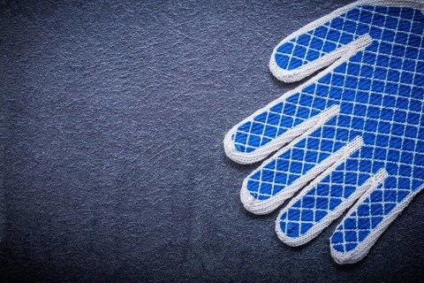Protective gloves on black background copyspace construction concept